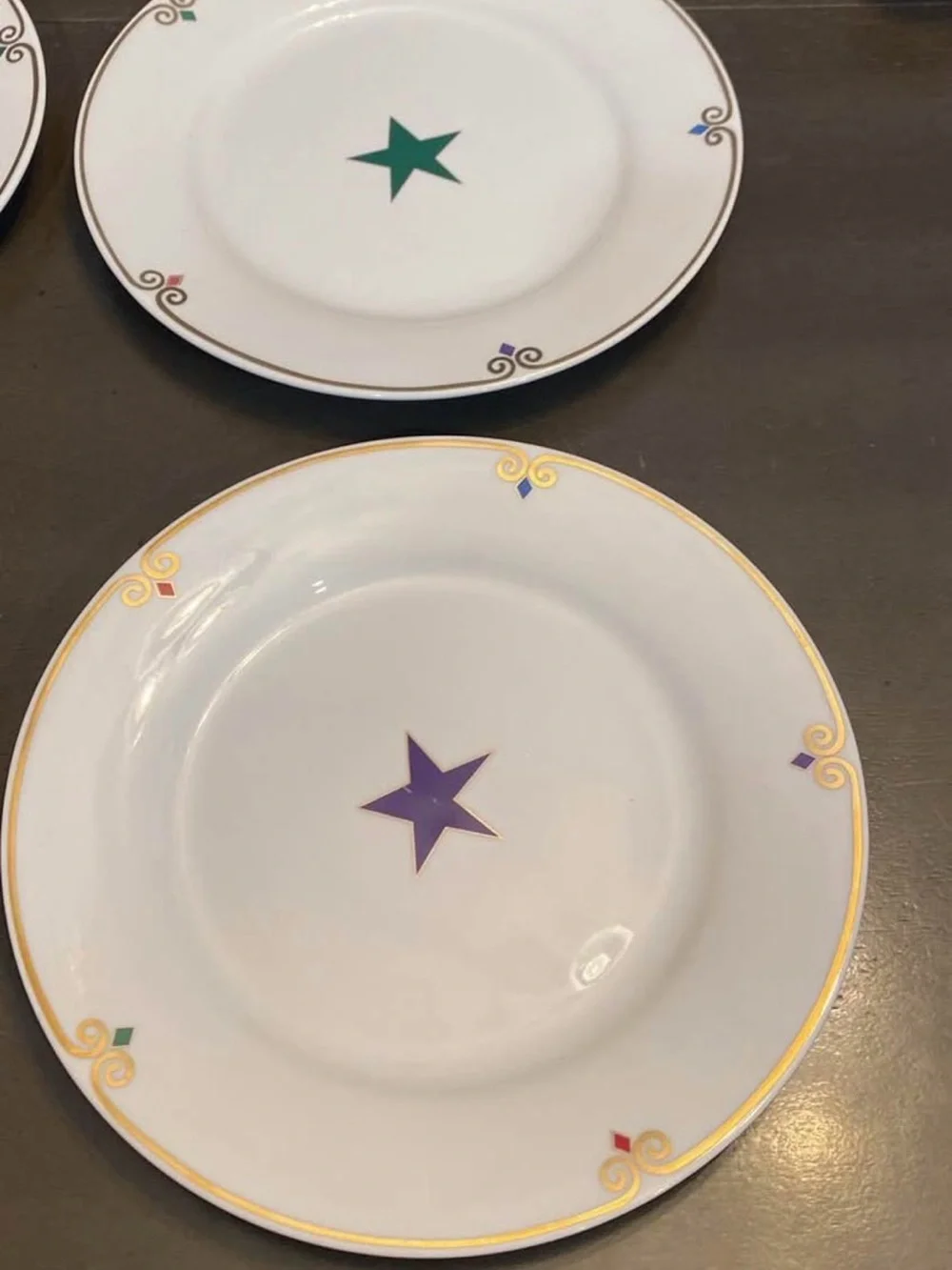 Pier 1 White  Plates with Multicolor Star Accents and Gold Trim